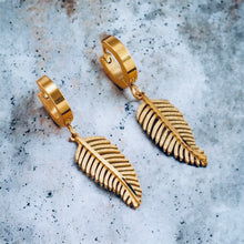 Stainless steel sand pressed feather huggies. Gold, earrings.